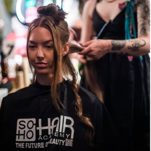 A woman is getting her hair styled at a beauty salon in Omaha.